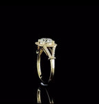 Side profile shot displaying the cathedral setting and split-shank architecture on 14k yellow gold band.