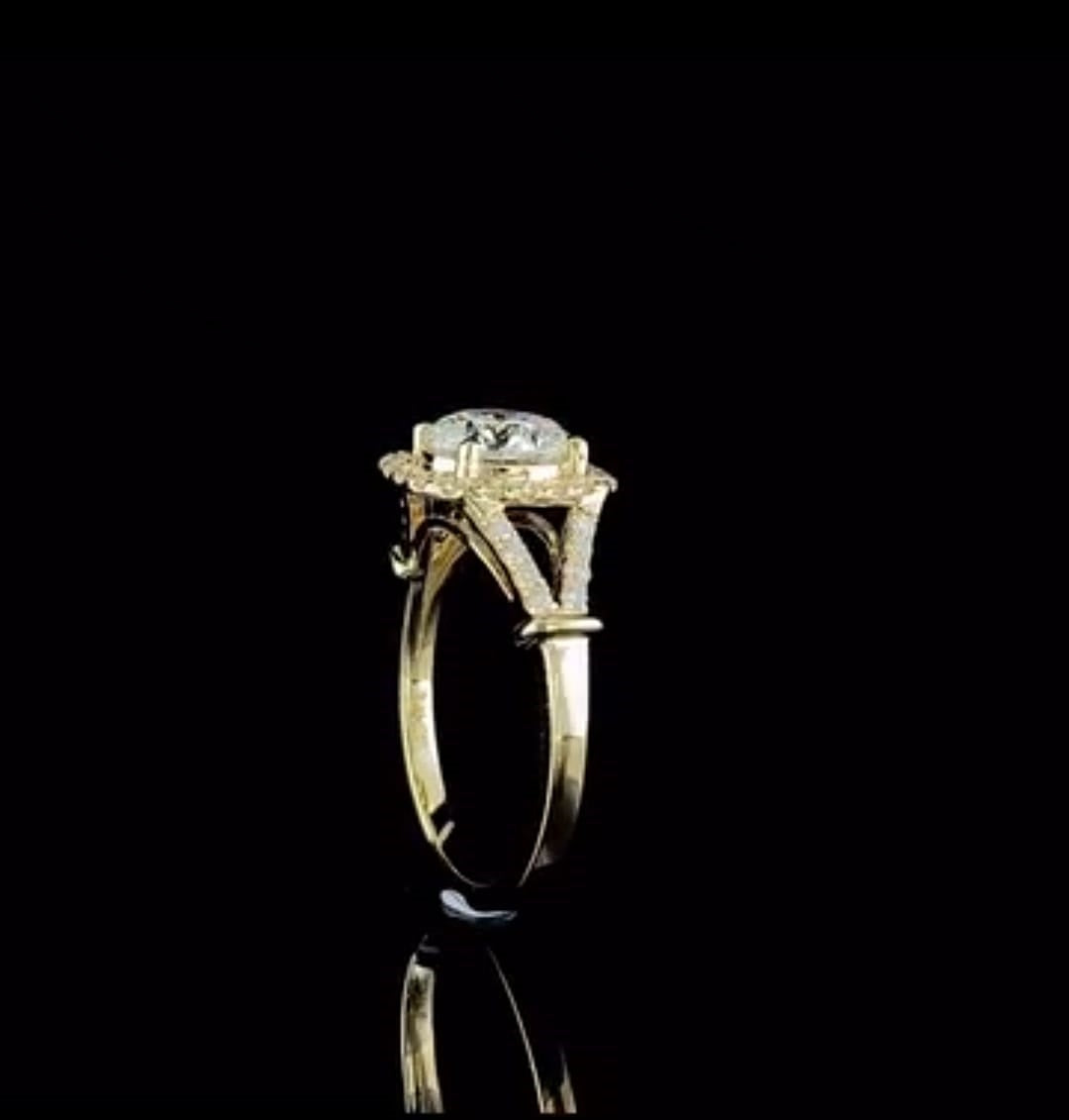 Side profile shot displaying the cathedral setting and split-shank architecture on 14k yellow gold band.