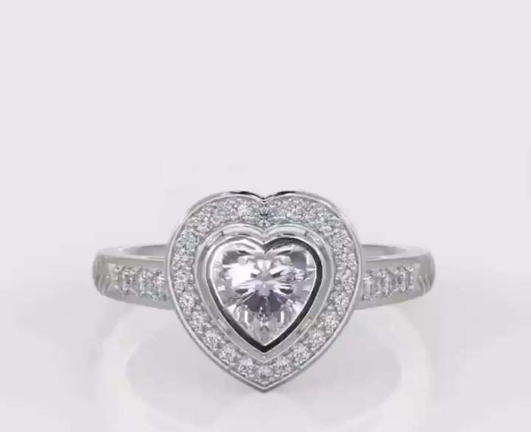 Direct top-down view of a 2 carat heart cut lab grown diamond engagement ring with bezel halo.