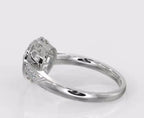 High-angle side view displaying the carved shank pattern, filigree gallery, and bezel halo setting.
