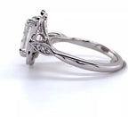 Side profile view showing the basket elevation, leaf shoulder accents, and polished shank of white gold ring.