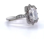 Side perspective highlighting the scalloped milgrain halo edge and double claw prongs on 3 CT emerald ring.