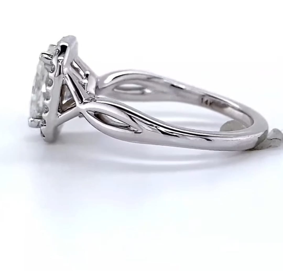 Side profile view showing the polished twist split shank and cathedral halo setting on white gold ring.