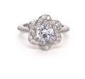 Front view of 2 CT round cut lab grown diamond engagement ring with floral swirl halo and white metal band.