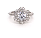 Front view of 2 CT round cut lab grown diamond engagement ring with floral swirl halo and white metal band.