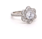 Close-up view highlighting the intricate flower petal swirl halo setting around a 2 CT round lab grown diamond.