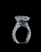High-angle side view showcasing the cathedral setting and crisscross under-gallery prongs of a 4 carat cushion lab diamond ring.