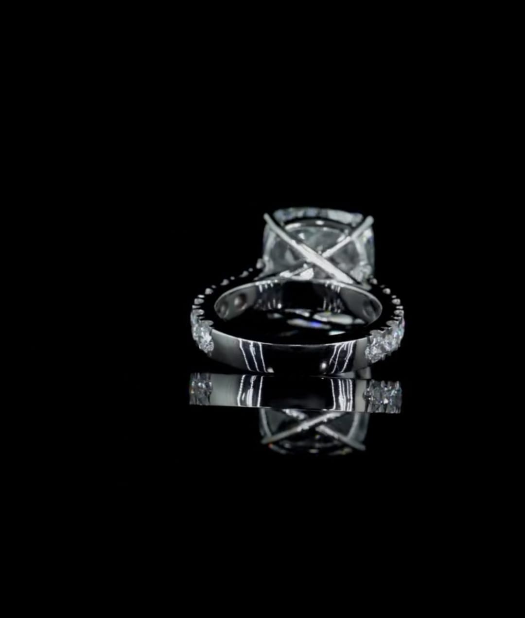 Bottom-up gallery view highlighting the cross-prong setting and smooth inner band of a 4 CT cushion cut lab diamond ring.