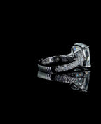 Angled shot showing the structural cathedral setting and pave-set band of a 4 CT cushion lab diamond engagement ring.