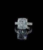Direct top-down view of a brilliant 4 CT cushion cut lab grown diamond engagement ring with pave side stones.