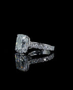 Side profile view emphasizing the large 4 CT cushion cut diamond stone height and paved diamond band on a black background.