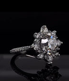 Angled top view of a 3 ct round cut lab diamond ring with a starburst floral halo setting