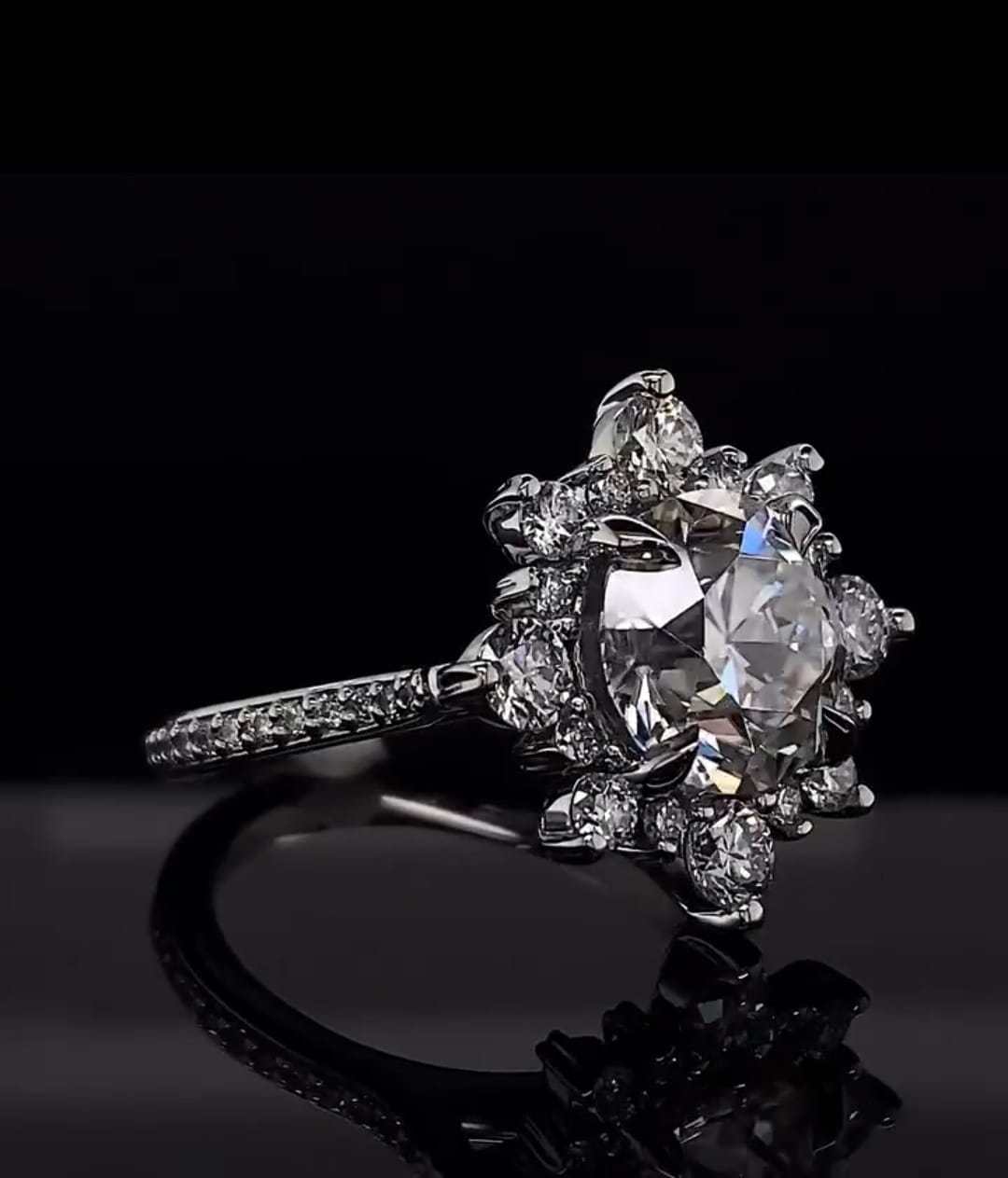 Angled top view of a 3 ct round cut lab diamond ring with a starburst floral halo setting