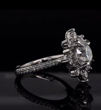 Side angle perspective of a 3ct round lab diamond engagement ring on a reflective black background