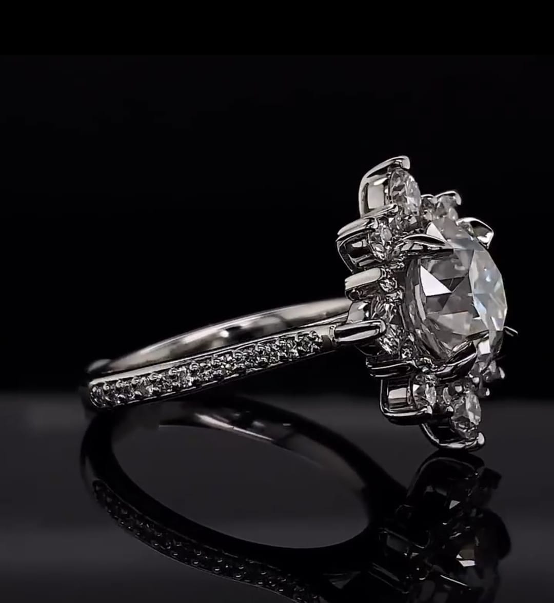 Side angle perspective of a 3ct round lab diamond engagement ring on a reflective black background