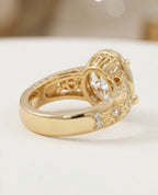 Side profile of a yellow gold vintage engagement ring showing intricate floral engraving and diamond accents on the band