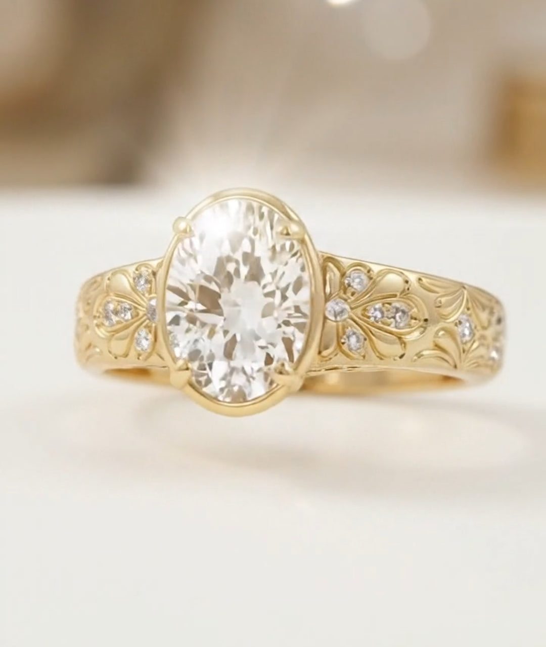 Detailed undergallery view of a gold oval engagement ring highlighting the open-work basket and smooth polished inner band