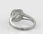 Underside view of a 2 carat cushion cut lab grown diamond ring showing the hollow gallery basket setting