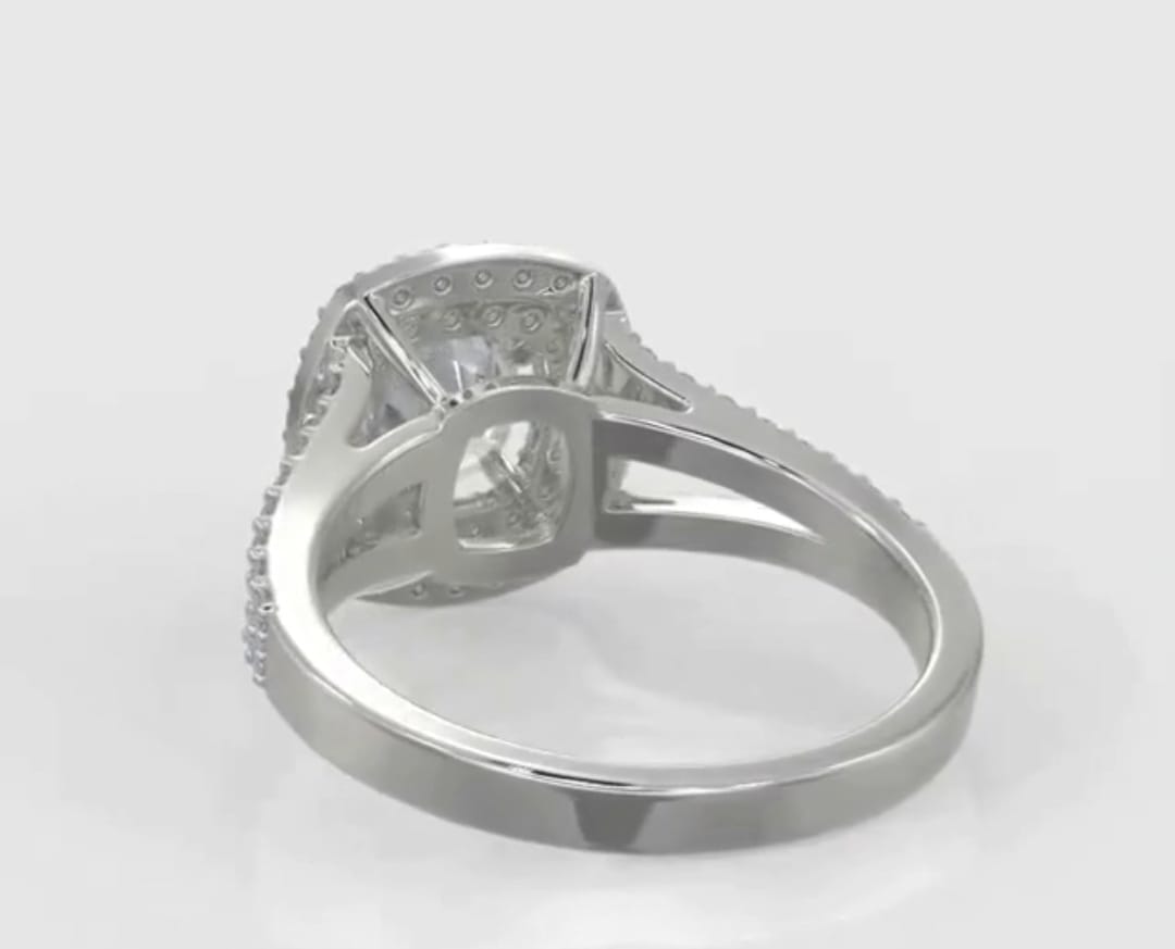 Underside view of a 2 carat cushion cut lab grown diamond ring showing the hollow gallery basket setting
