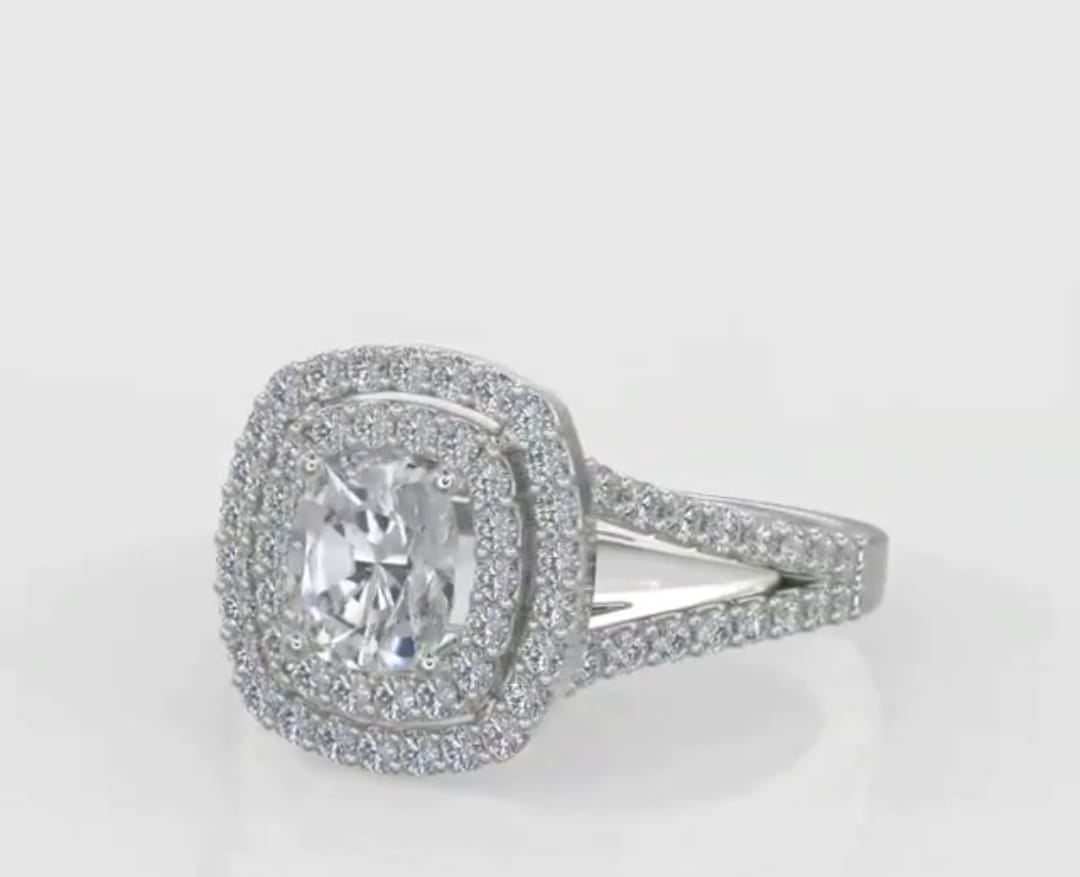 Three-quarter perspective of a 2 ct cushion cut lab diamond engagement ring on a clean light background