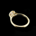 Side profile view of a 2ct round lab diamond engagement ring showing the detailed basket and polished band