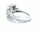 Side perspective of 2 carat round lab grown diamond engagement ring with hand-engraved band