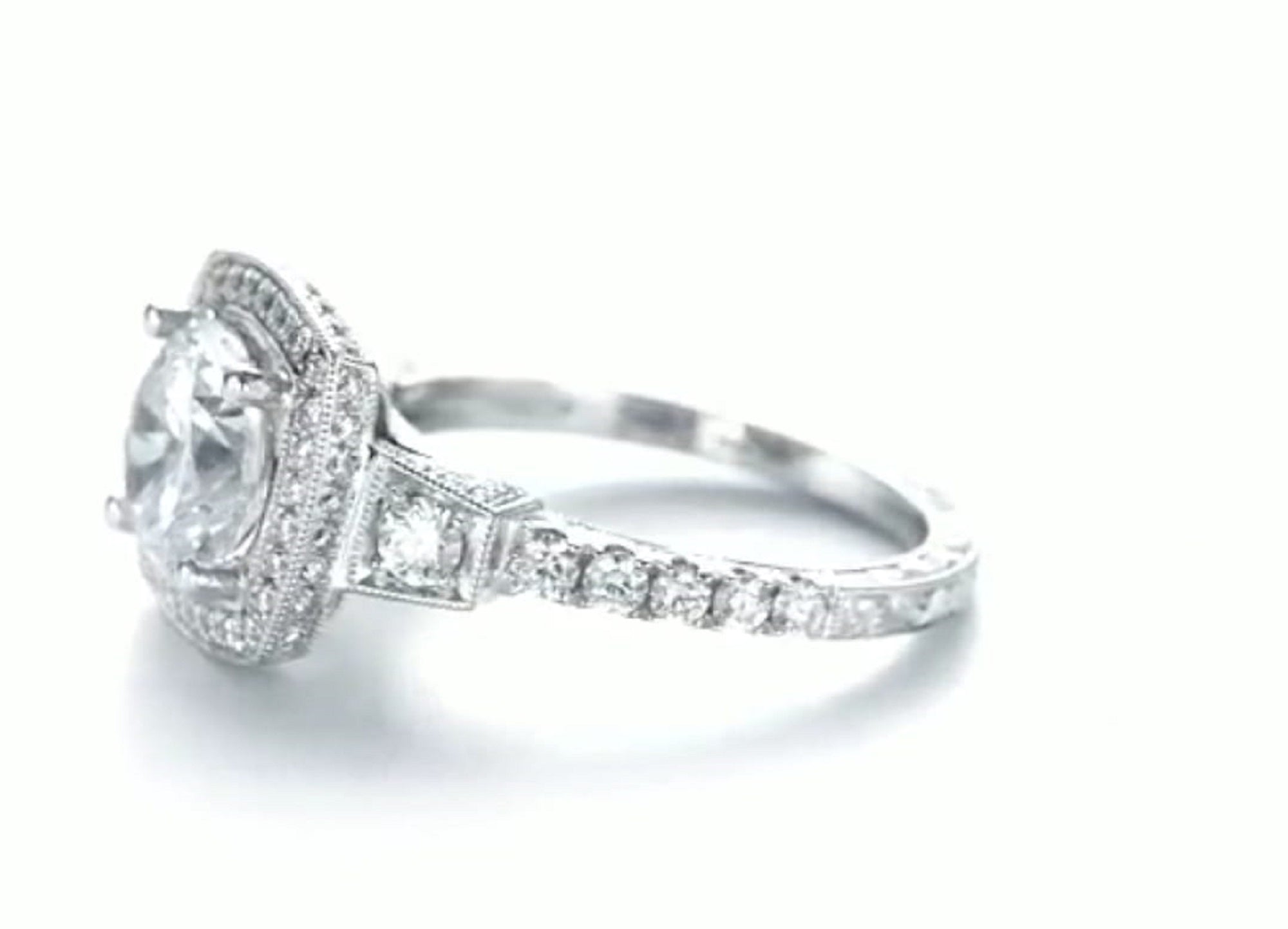 Angled view showing milgrain halo details and round lab diamond center