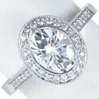 Top view of 3 carat oval lab grown diamond ring with milgrain bezel halo and pave band