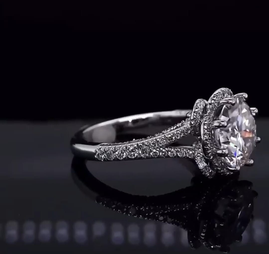 Side perspective showing split pave diamond cathedral shank and round lab diamond center stone
