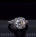 Direct top-front view showing 3 carat round cut lab diamond with floral scalloped pave halo