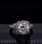Direct top-front view showing 3 carat round cut lab diamond with floral scalloped pave halo