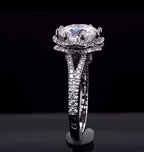 Profile view of split cathedral shank and double-tier scalloped halo structure on white gold band