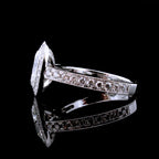 Side profile view showing pave diamond band with milgrain border and 750 gold stamp