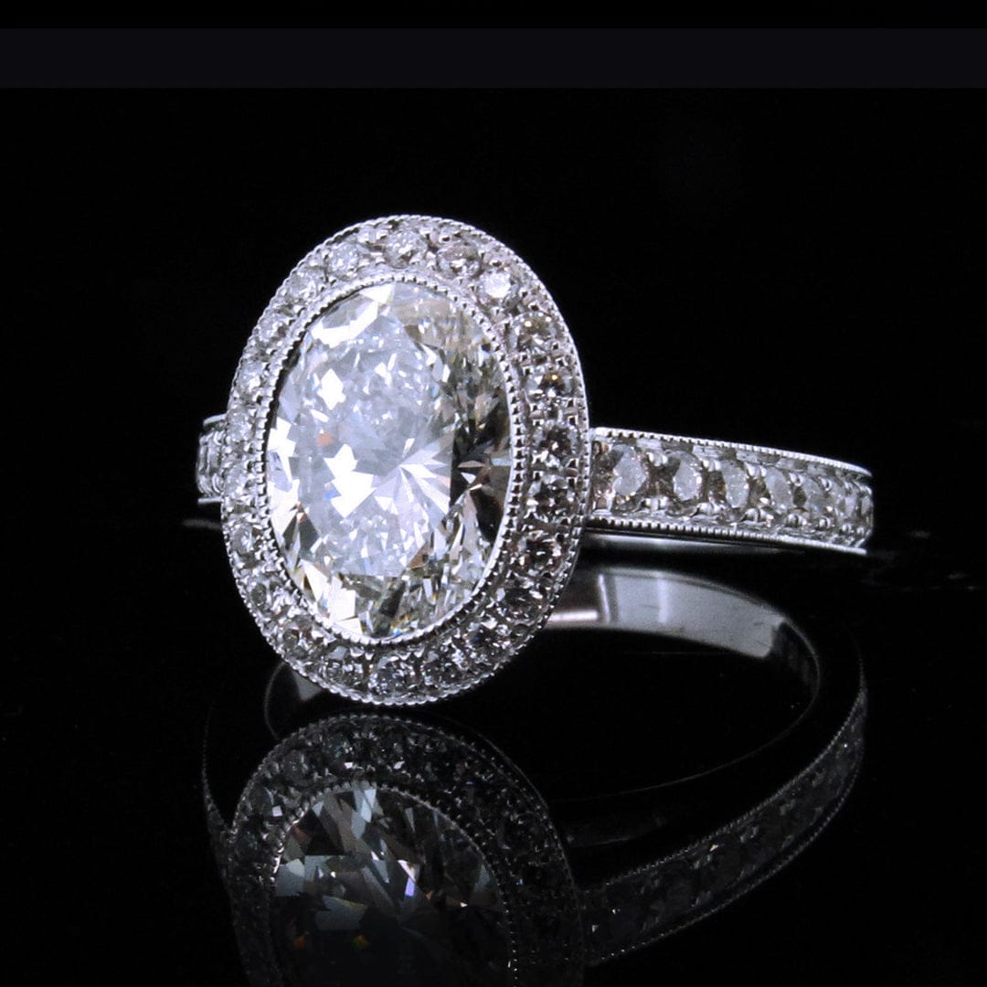 Perspective reflection view of 3 CT oval lab diamond ring with pave band and vintage milgrain details