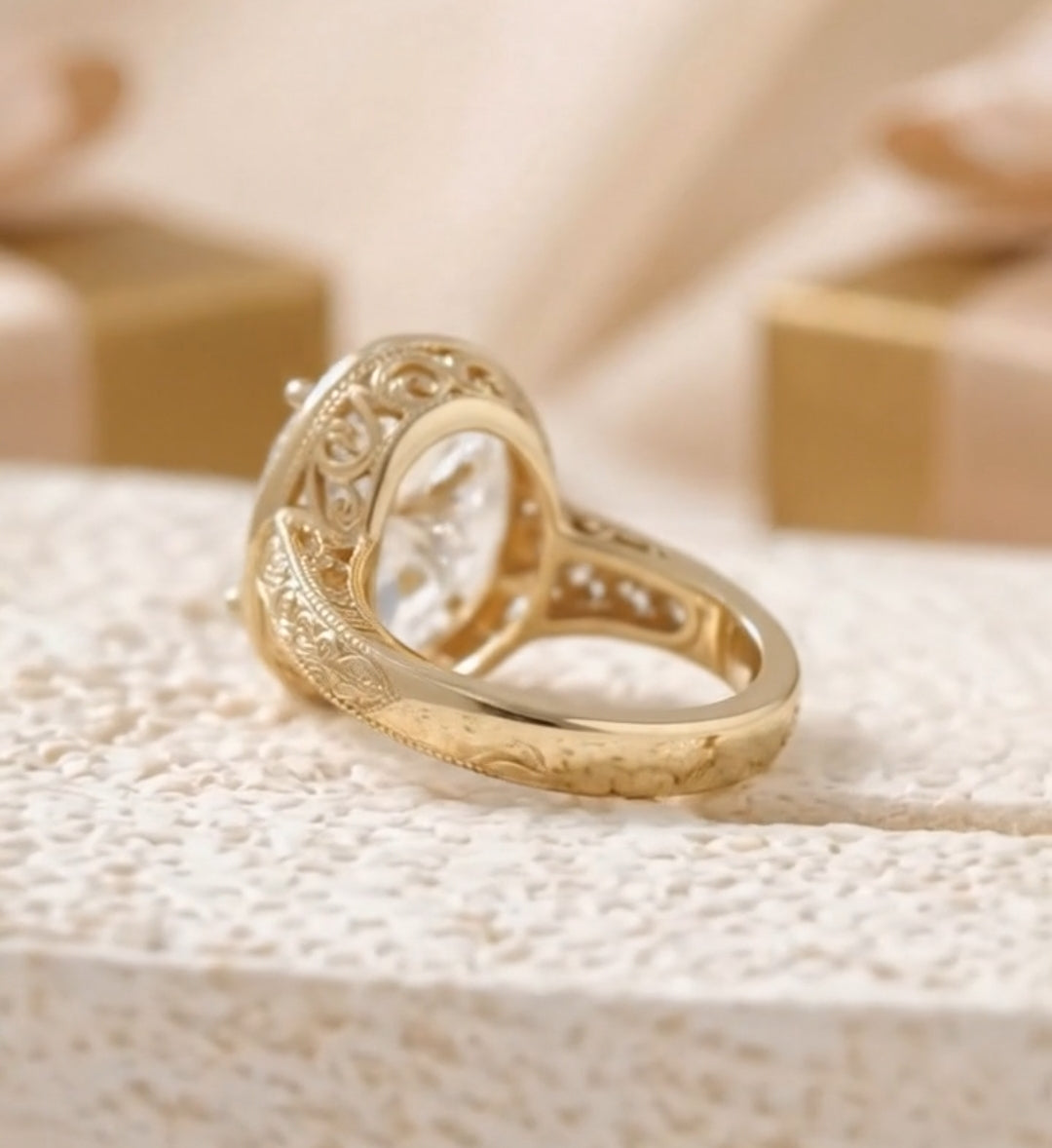 Side profile of a vintage gold engagement ring showing intricate scrollwork engraving along the tapered band