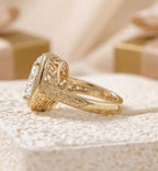 3 CT Oval Cut vintage gold engagement ring showing intricate scrollwork engraving along the tapered band