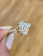 Close-up angle showing 3 carat oval lab diamond held by claw prongs on rose gold band