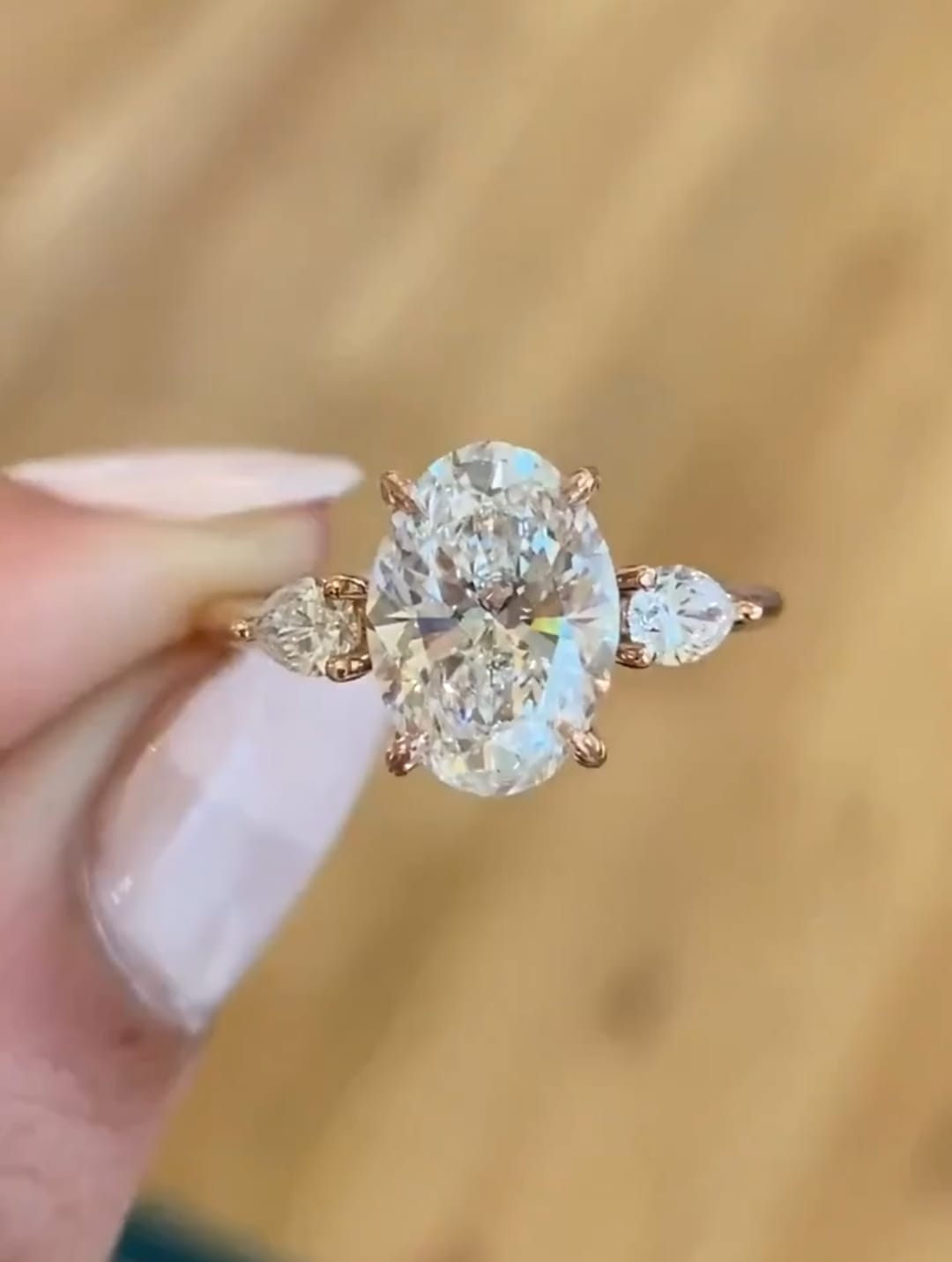 Direct top front view highlighting fire of 3 CT oval lab diamond with pear side accents