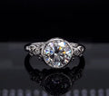 Front view of 3 CT round brilliant lab grown diamond ring with bezel setting and filigree shoulders