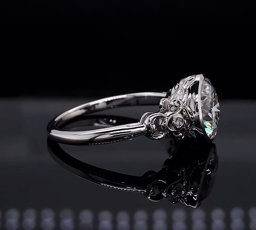 Side view showing the raised bezel basket structure with intricate vintage filigree and side accents