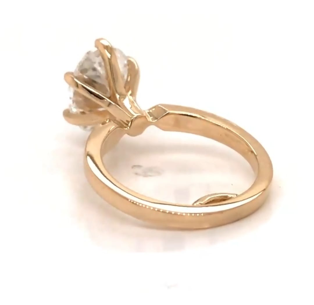Low angle view highlighting the yellow gold basket construction of 3 carat oval solitaire ring