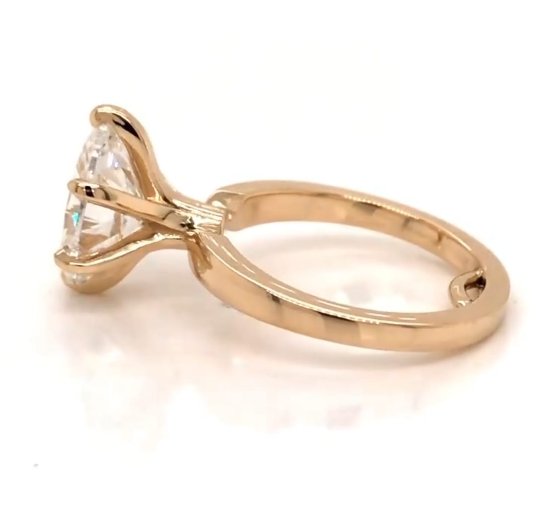 Side angle view showing polished yellow gold band and 6-prong head structure