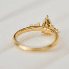 Underside and profile view of the basket setting on a yellow gold pear cut lab diamond engagement ring.