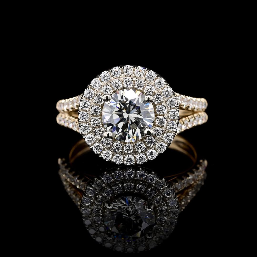 Top-down view of a 2 carat round lab-created diamond double halo ring in yellow gold with mirror reflection.