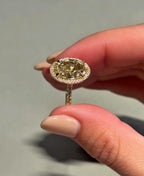 Side angle view of a 3 CT yellow oval lab diamond engagement ring with a pavé-set yellow gold band.