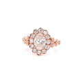 Front view of a 2 carat oval lab grown diamond ring with a floral scalloped halo in 14k rose gold