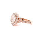 Angle view showing the scalloped halo and side accents of a 2ct oval lab diamond ring in rose gold