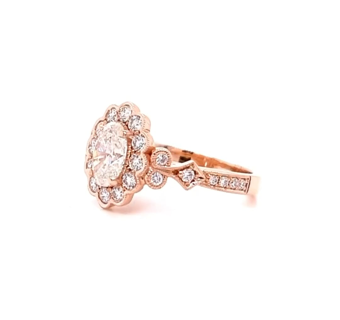 Angle view showing the scalloped halo and side accents of a 2ct oval lab diamond ring in rose gold