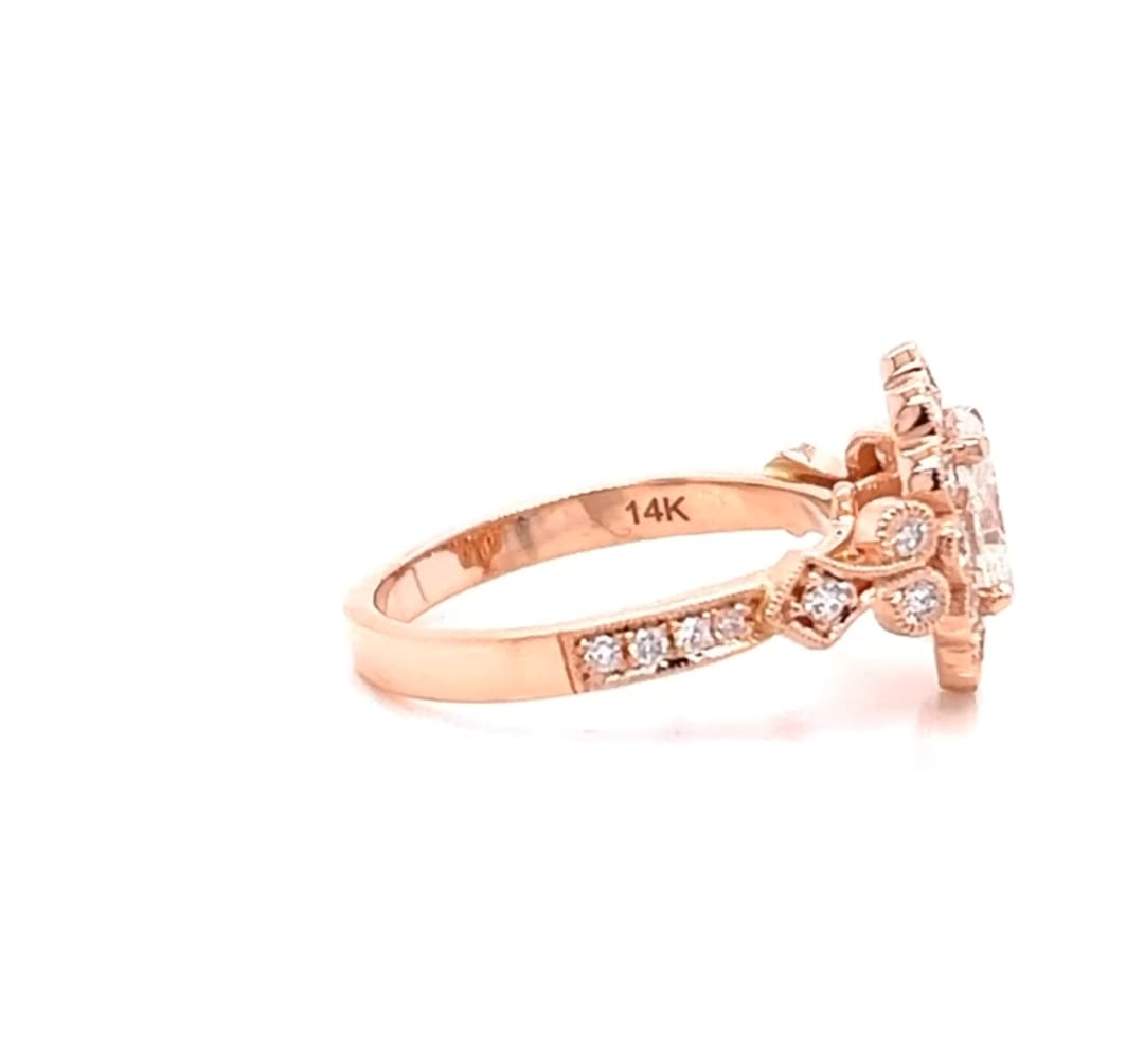 Close-up side view of a rose gold vintage oval lab diamond ring showing the 14K quality hallmark