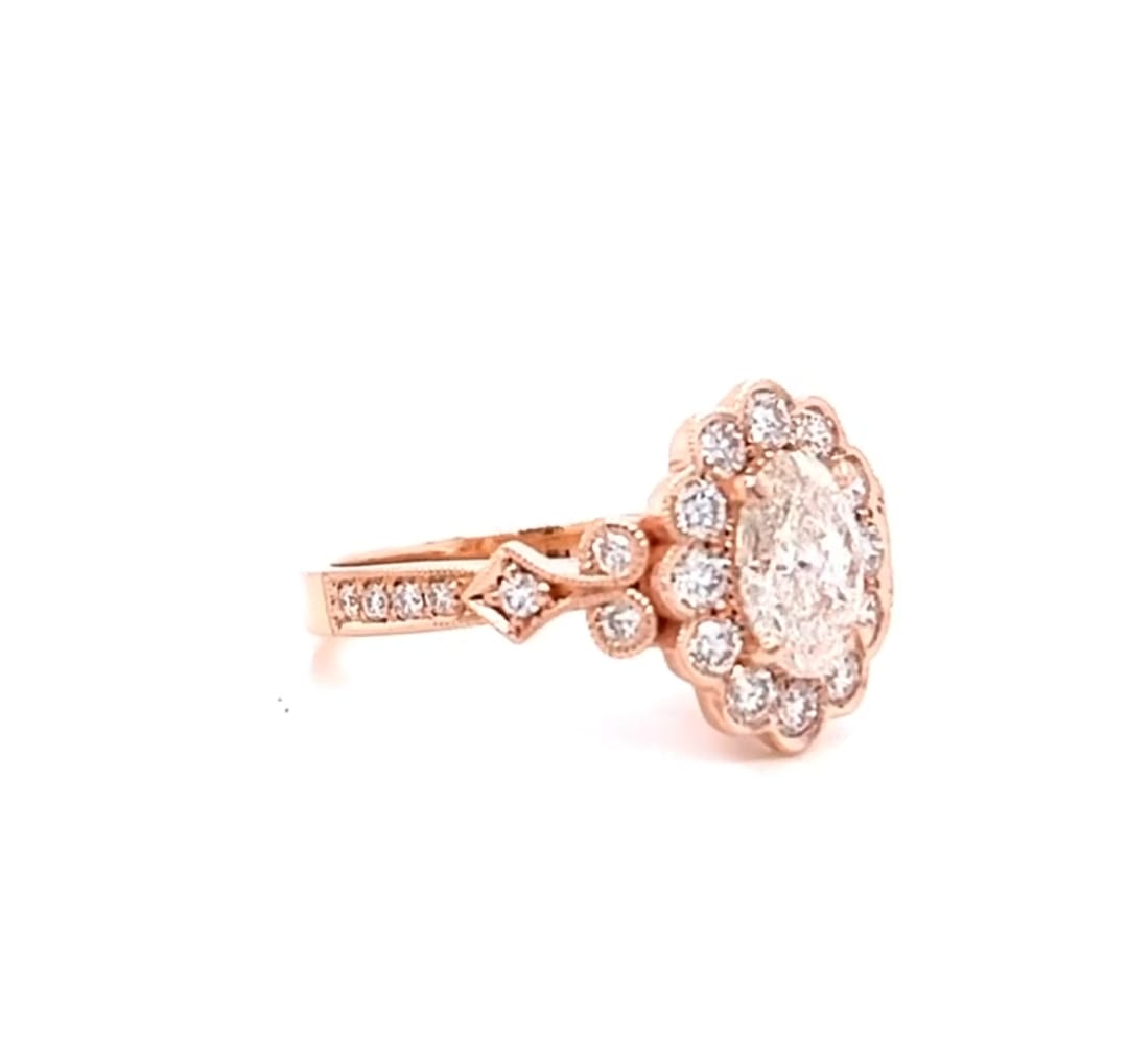 Perspective angle highlighting the milgrain edges and floral halo of a 2 carat oval lab diamond ring
